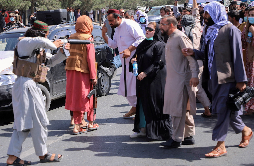 A member of the Taliban forces points his gun at protesters, as Afghan demonstrators shout slogans during an anti-Pakistan protest, near the Pakistan embassy in Kabul, Afghanistan September 7, 2021. u00e2u20acu201d Reuters pic