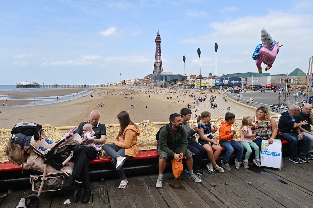 People relax on benches set out on the Central Pier in Blackpool, north west England on September 4, 2021. u00e2u20acu201d AFP pic