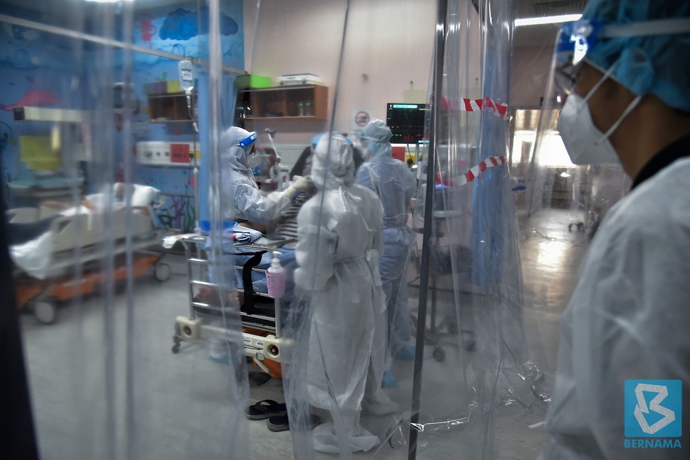 Medical staff donning full personal protective equipment (PPE) performing their duty in the Covid-19 ward at Labuan Nucleus Hospital on June 27. u00e2u20acu201d Bernama pic