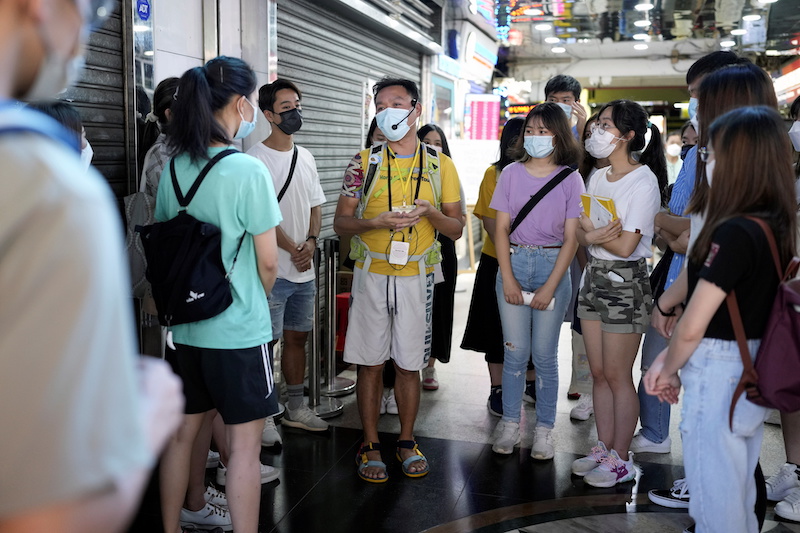 Tour guide Michael Tsang speaks to tourists during a tour visiting refugee communities in Hong Kong, China August 21, 2021. u00e2u20acu201d Reuters pic