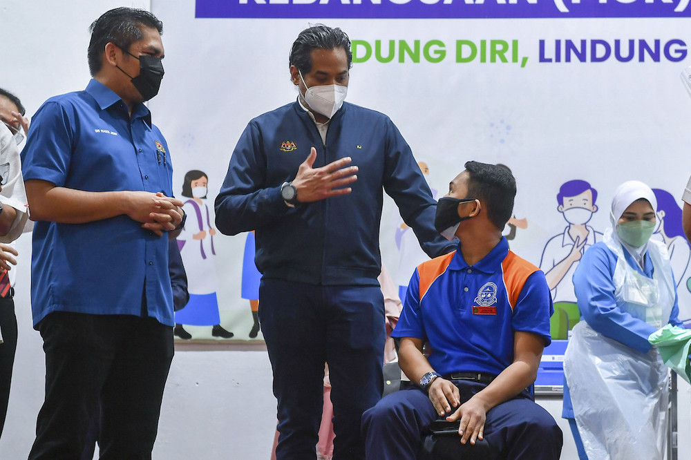 Senior Education Minister Datuk Dr Radzi Jidin and Health Minister Khairy Jamaluddin speak with a student who had received his Covid-19 vaccination in Putrajaya, September 20, 2021. u00e2u20acu201d Bernama pic