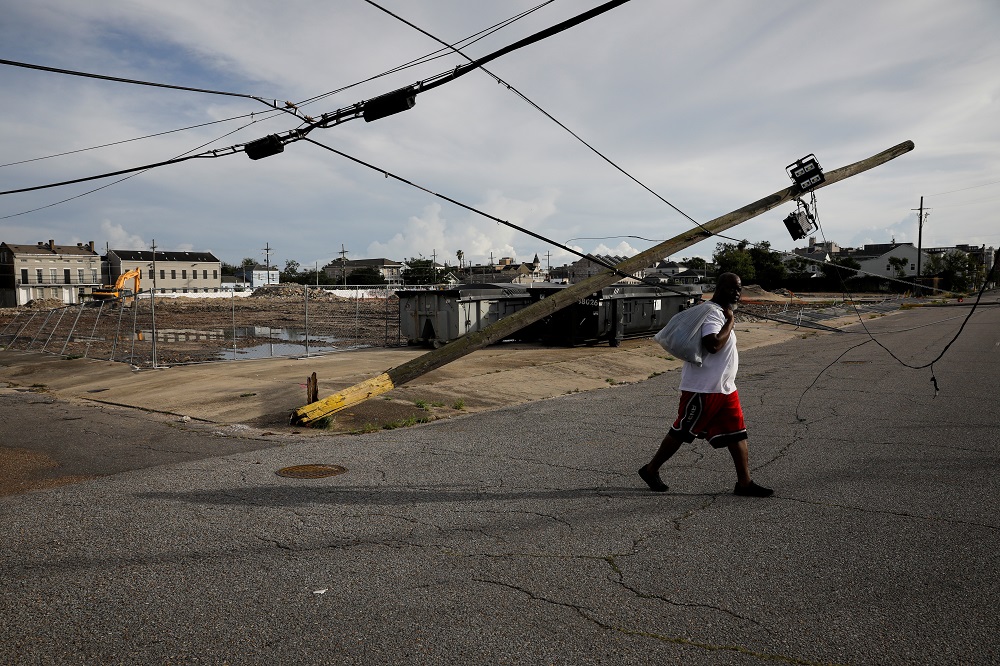 A man walks past a damaged electric line in a street after Hurricane Ida made landfall in Louisiana, in New Orleans, Louisiana August 30, 2021. u00e2u20acu201d Reuters pic