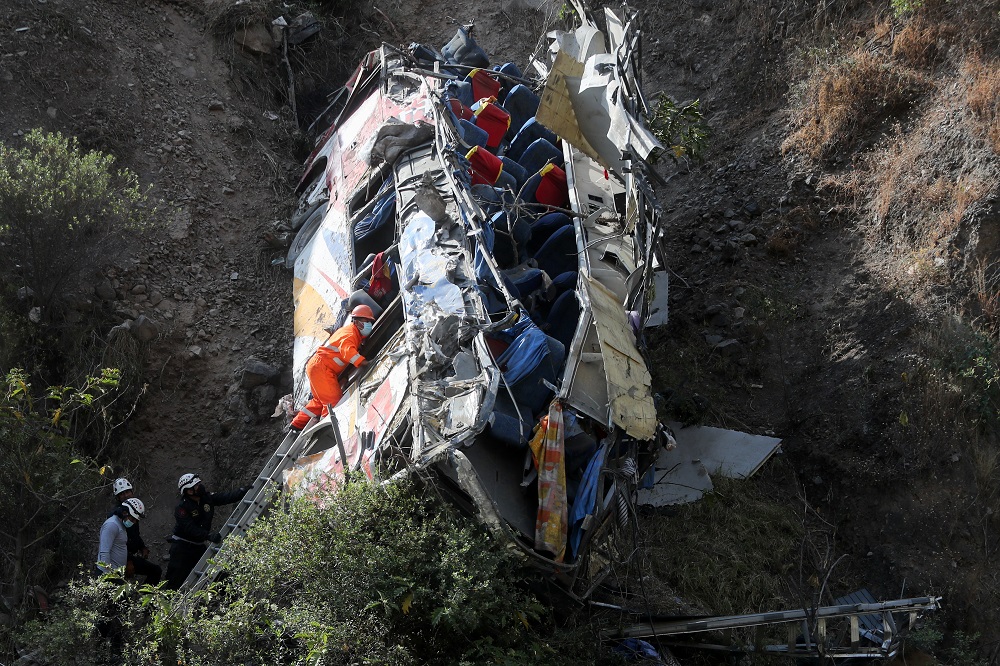 Rescue workers check a bus after it crashed, in Matucana, Peru, August 31, 2021. u00e2u20acu201d Reuters pic