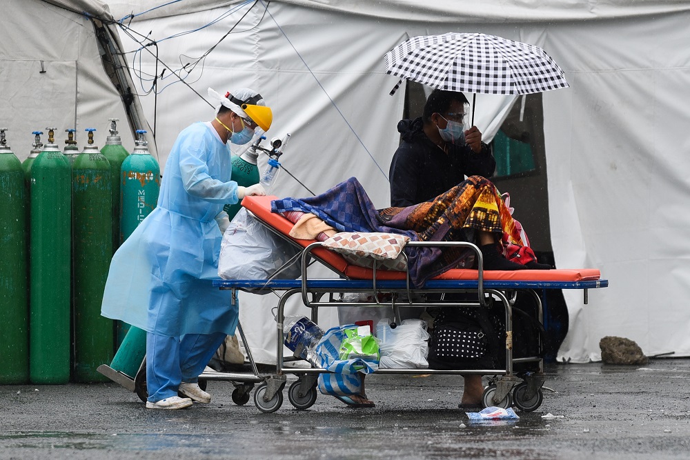 A health worker wearing personal protective equipment as protection against the coronavirus disease transports a suspected Covid-19 patient, at Sta. Ana Hospital, in Manila September 8, 2021. u00e2u20acu201d Reuters pic