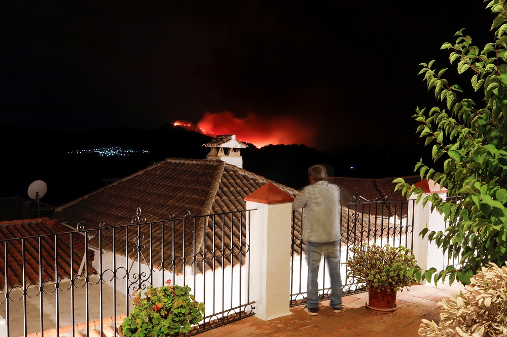 A man watches a wildfire from a balcony near the town of Pujerra, which was evacuated, in Cartajima, near Estepona, Spain September 12, 2021. u00e2u20acu201d Reuters pic