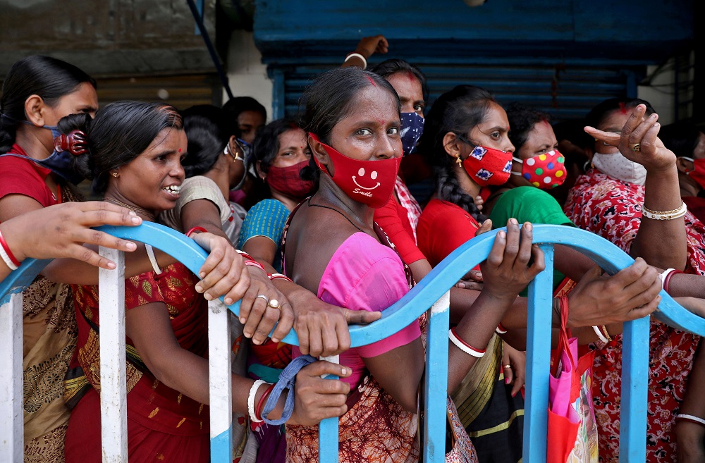 Women wait to receive a dose of COVISHIELD vaccine, a coronavirus disease  vaccine manufactured by Serum Institute of India, outside a vaccination centre in Kolkata August 31, 2021. u00e2u20acu201d Reuters pic