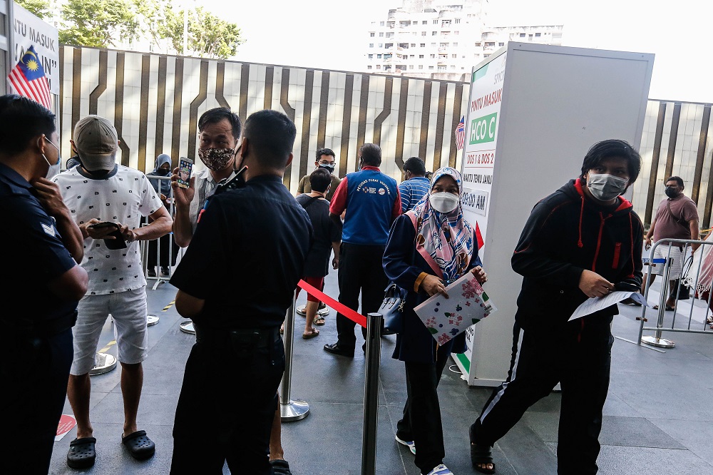 Parents accompany their children to receive their Covid-19 vaccination shot at the Subterranean Penang International Convention and Exhibition centre in Bayan Baru September 22, 2021. u00e2u20acu201d Picture by Sayuti Zainudin