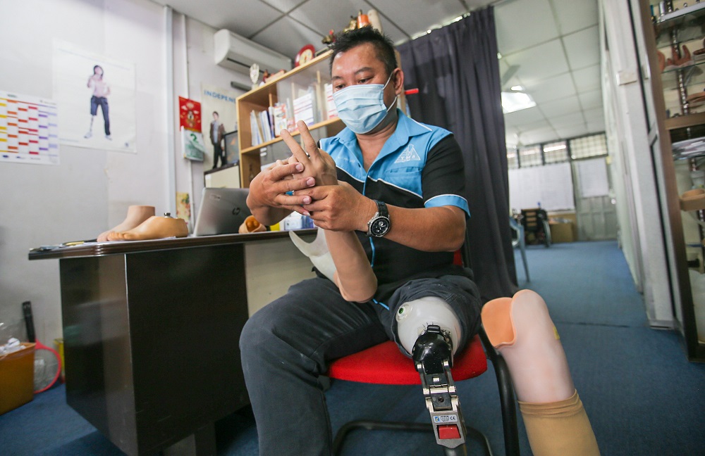 From working with a Kuala Lumpur-based company producing prosthetic limbs, amputee Allen Ho Wing Luang began having a go at it on his own in 2005. —  Picture by Farhan Najib