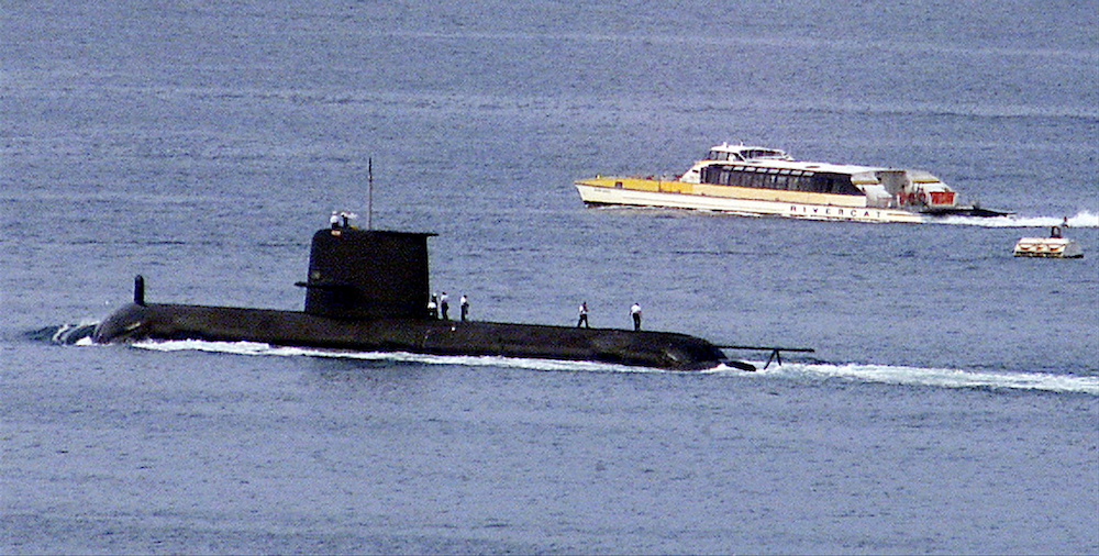 A Rivercat ferry passes by the Royal Australian Navy's Collins-class submarine HMAS Waller as it leaves Sydney Harbour on May 4, 2020. u00e2u20acu201d Reuters file pic