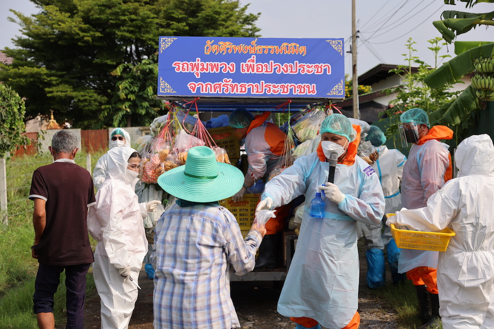 Buddhist monks wearing Personal Protective Equipment (PPE) donate food and other necessities to vulnerable people whose livelihoods have been hit hard by the Covid-19 pandemic on the outskirts of Bangkok September 18, 2021. u00e2u20acu201d Reuters pic