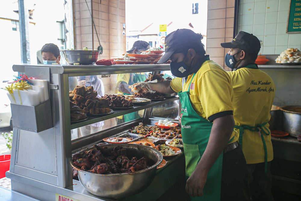 Mohamed Nihmaphullah Syed Mustffa, manager of Nasi Kandar Ayam Merah — also known as Nasi Ganja — said their food is only available in Perak. — Picture by Farhan Najib 