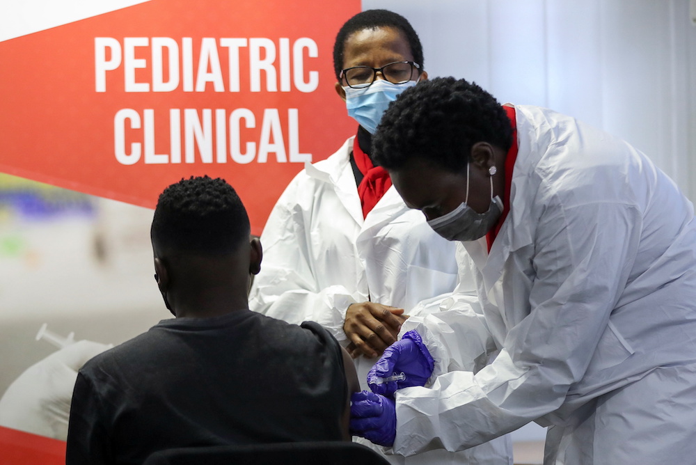 A health worker administers a vaccine during the launch of the South African leg of a global Phase III trial of Sinovac's Covid-19 vaccination of children and adolescents, in Pretoria, South Africa, September 10, 2021. u00e2u20acu201d Reuters pic
