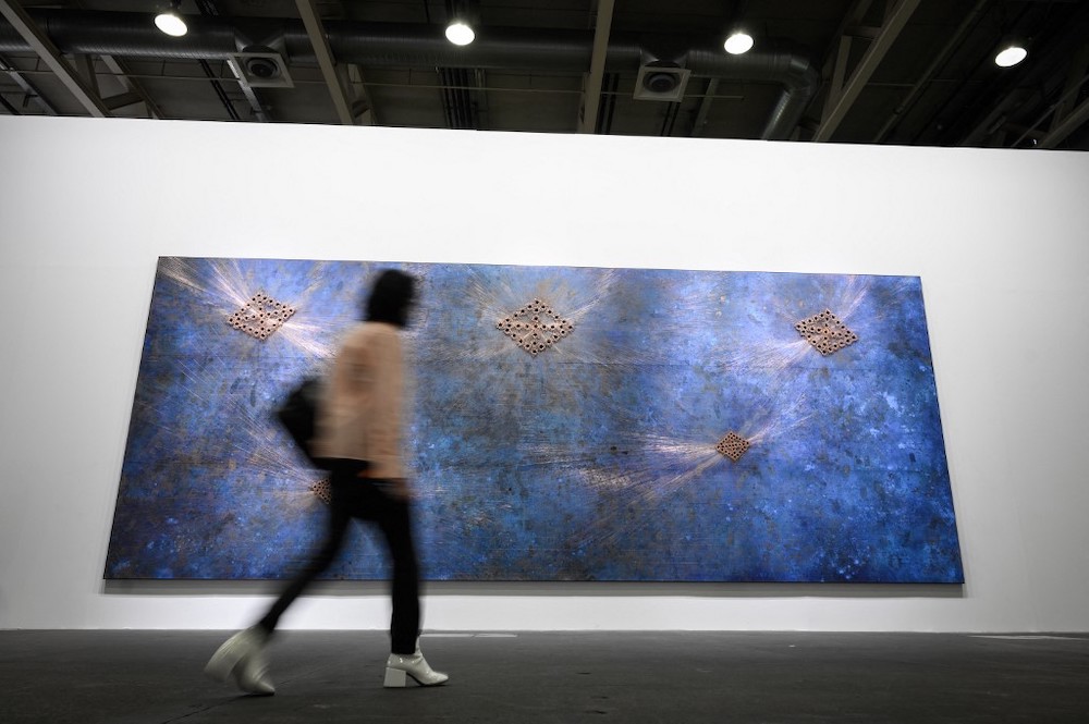 A visitor walks past ‘A Brief History of Known’ 2021 an artwork by Jamaican born, New York City based artist Nari Ward, displayed at the Unlimited sector of Art Basel, the world’s premier modern and contemporary art fair, in Basel, on September 21,