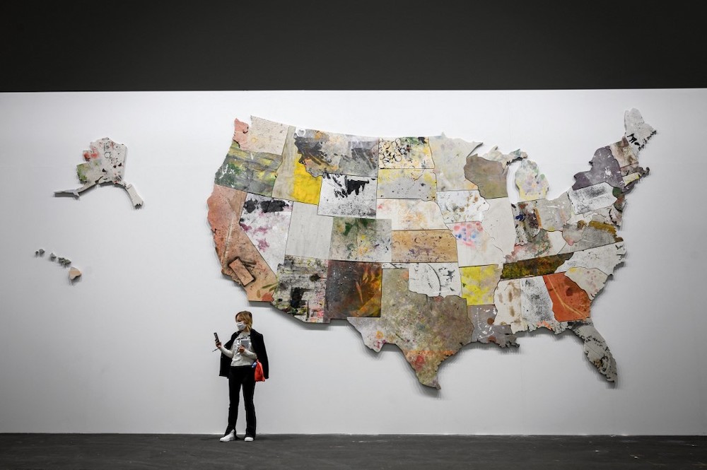 A visitor stands by an artwork by US pop artist Nate Lowman called ‘Untitled’ 2013/2015 and displayed at the Unlimited sector of Art Basel, the world’s premier modern and contemporary art fair, in Basel, on September 21, 2021. — AFP pic