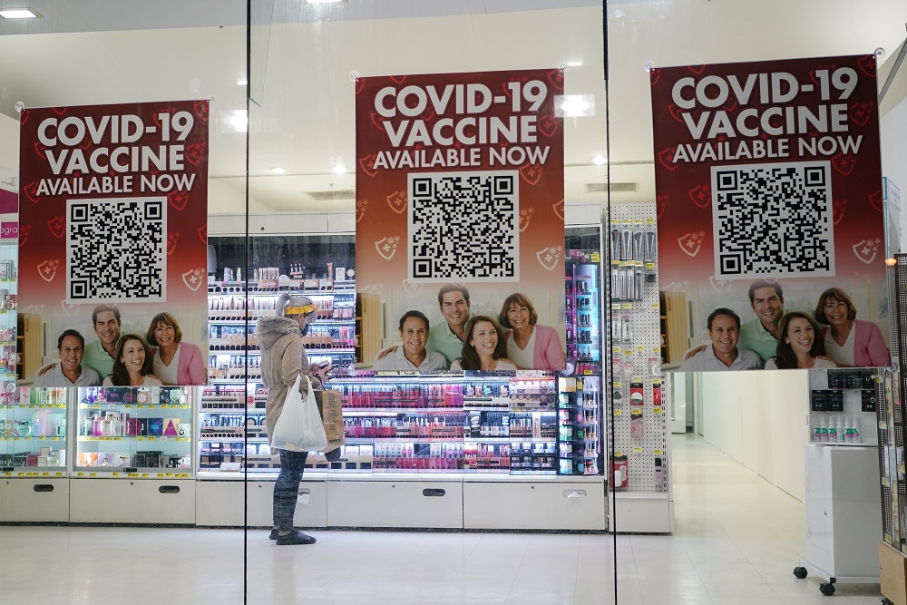 A customer shops inside a city centre pharmacy advertising Covid-19 vaccine availability in Sydney, Australia September 14, 2021. u00e2u20acu2022 Reuters pic