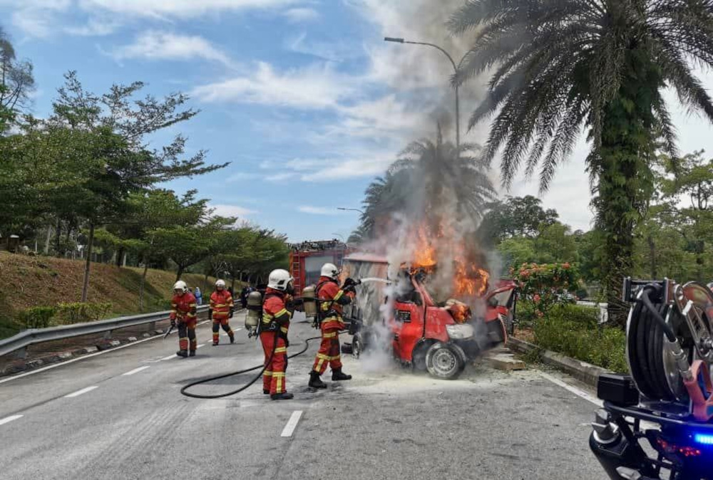 Firemen douse flames from the burning courier lorry where the driver was trapped after a crash along Jalan Tasek Utara in Johor Baru, September 28, 2021. u00e2u20acu201d Picture courtesy of the Johor Fire and Rescue Departmentnn