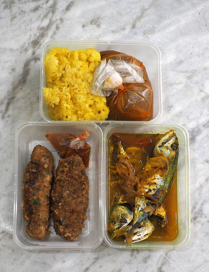 All the dishes are packed in boxes ready for takeaway like the deep fried Hainanese meat rolls with a piquant chilli sauce