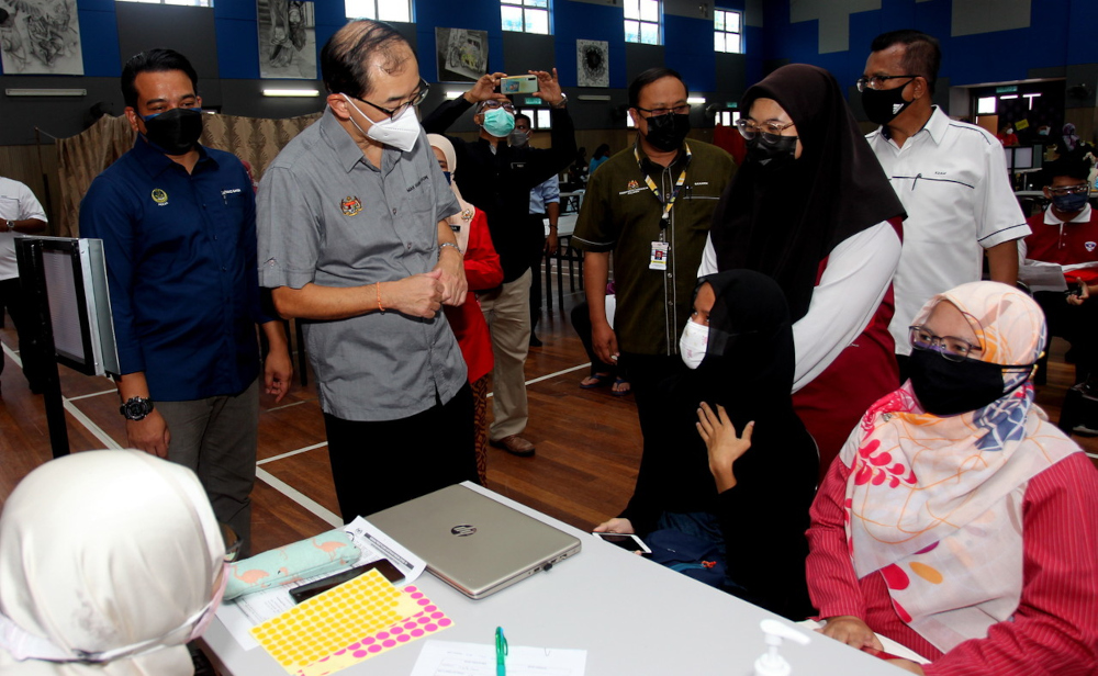 Deputy Education Minister I Datuk Dr Mah Hang Soon speaks to a student at SMK Proton City vaccination centre (PPV) in Tanjung Malim, September 24, 2021. u00e2u20acu201d Bernama pic 