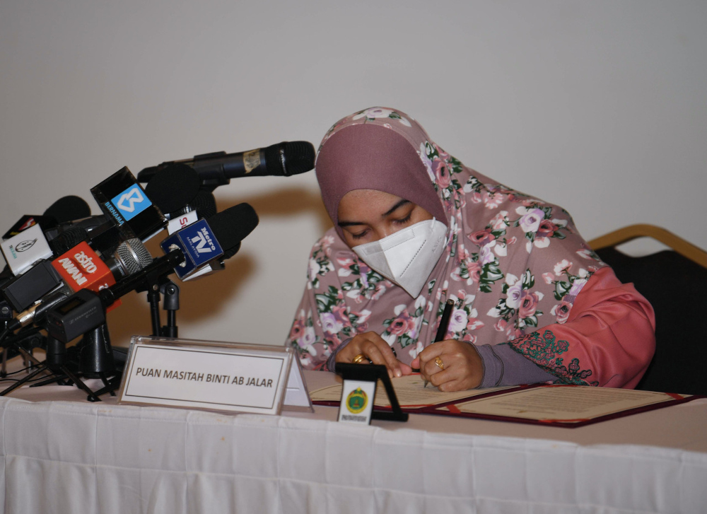 Masitah Ab Jalar signing her declaration of repentance document at the Sultan Salahuddin Abdul Aziz Shah Mosque in Shah Alam, September 27, 2021. u00e2u20acu201d Bernama pic 