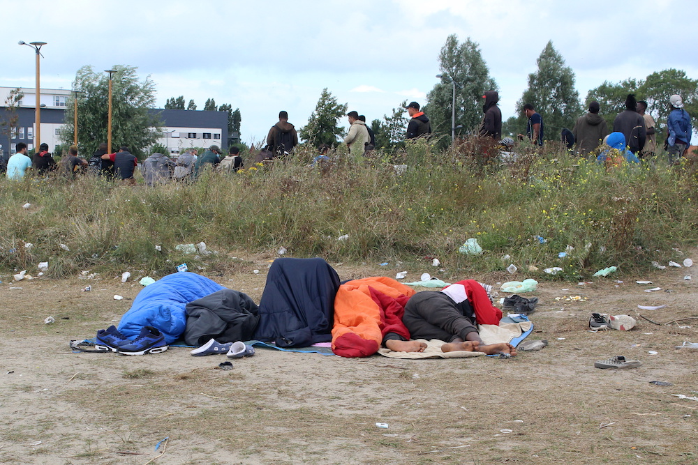 Migrants sleep in sleeping bags at a makeshift migrant camp near the hospital in Calais, France, September 10, 2021. u00e2u20acu201d Reuters picnn