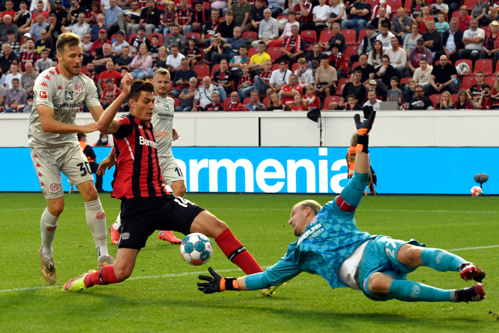 Leverkusenu00e2u20acu2122s Patrik Schick attempts to score past Mainz goalkeeper Robin Zentner during the German first division Bundesliga match in Leverkusen, western Germany, September 25, 2021. u00e2u20acu201d AFP pic 