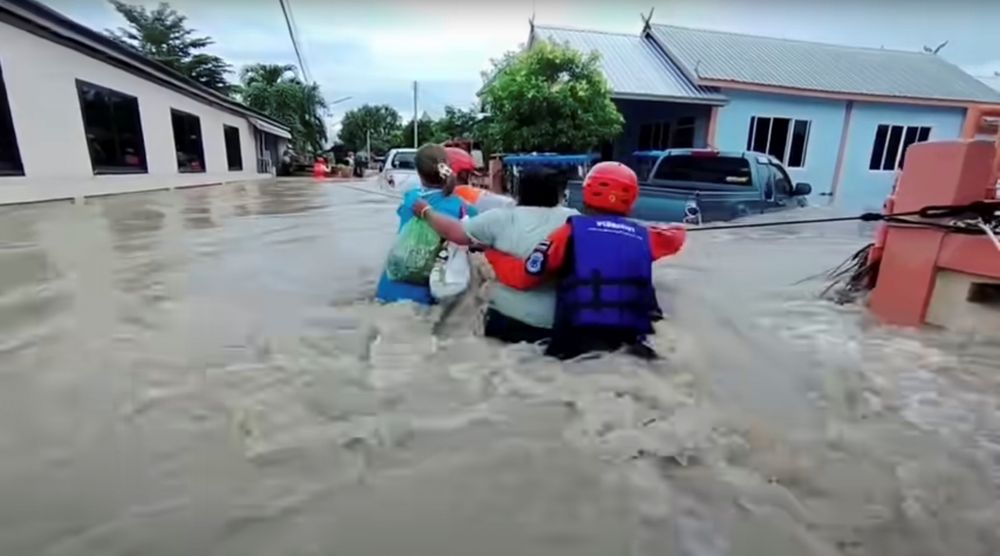 Rescuers use a rope to carry victims across flood waters in the Chaiyaphum province, Thailand, in this screen grab taken from a video from social media September 28, 2021. u00e2u20acu201d Hook31 Thailand pic via Reuters