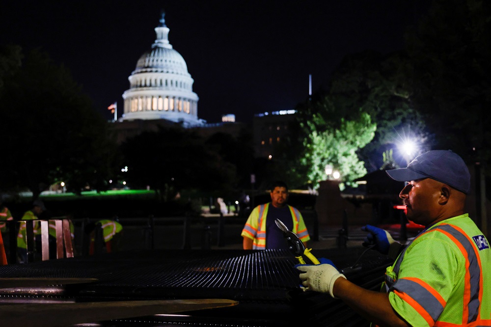 Workers prepare to install a security fence around the US Capitol ahead of an expected rally on Saturday in support of the January 6 defendants in Washington September 15, 2021. u00e2u20acu2022 Reuters pic 