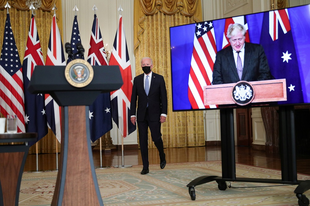 US President Joe Biden walks to the podium before his remarks on a National Security Initiative virtually with Australian Prime Minister Scott Morrison and British Prime Minister Boris Johnson, inside the East Room at the White House in Washington Septemb
