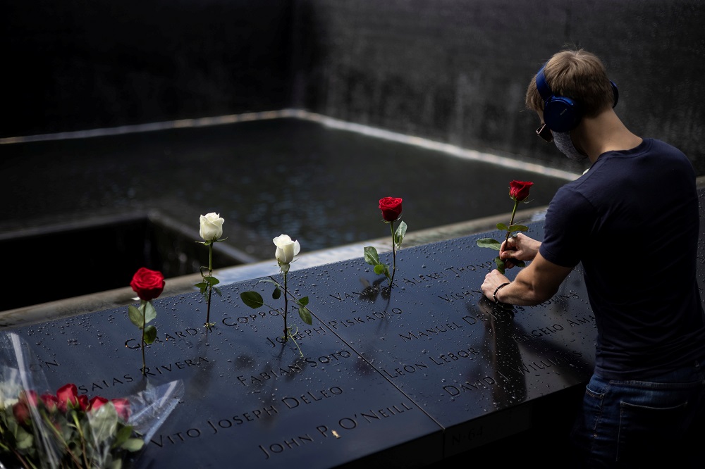 A man places roses at the 9/11 Memorial ahead of the 20th anniversary of the September 11 attacks in Manhattan, New York September 10, 2021. u00e2u20acu2022Reuters pic
