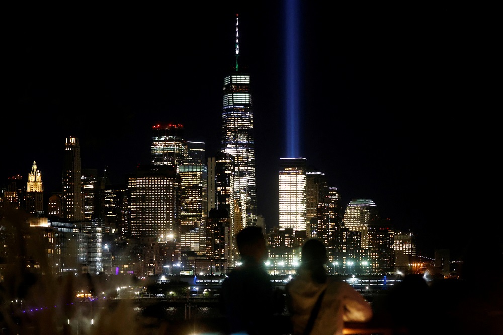 A couple views the Tribute in Light beams and the One World Trade Centre tower from Little Island park on the eve of the 20th anniversary of the September 11 attacks in Manhattan, New York September 10, 2021. u00e2u20acu2022 Reuters pic