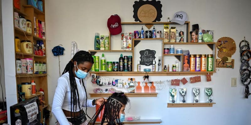 A hairdresser braids a customeru00e2u20acu2122s hair at a beauty salon, in downtown Caracas. u00e2u20acu201d ETX Studio picnnnnn
