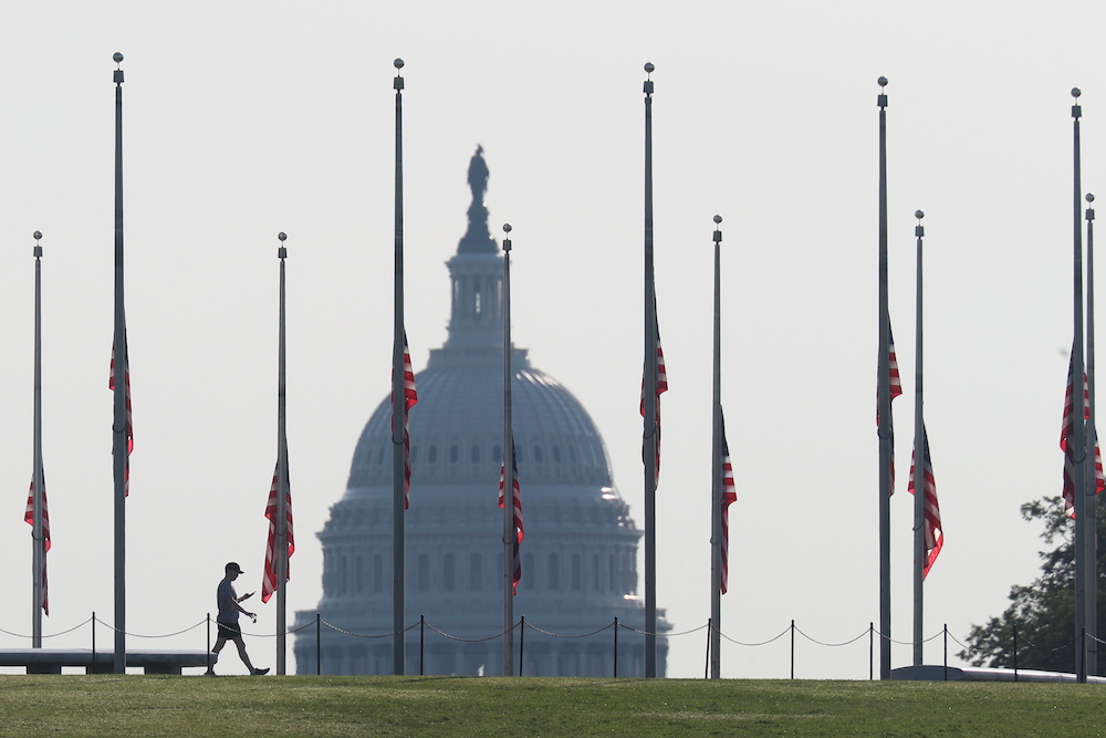 A visitor walks around the Washington monument as American flags are held at half staff in remembrance of the 20th anniversary of the September 11 attacks, on the National Mall near the US Capitol in Washington, US, September 11, 2021. u00e2u20acu201d Reuters picnn