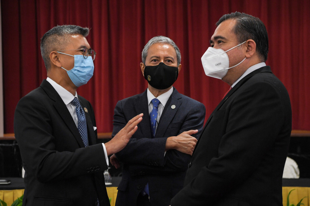 Finance Minister Datuk Seri Tengku Zafrul Abdul Aziz (left) chats with Dewan Rakyat Speaker Datuk Azhar Azizan Harun and Seremban MP Anthony Loke at the MoU signing ceremony between the federal government and PH at Parliament Building, September 13, 2021.