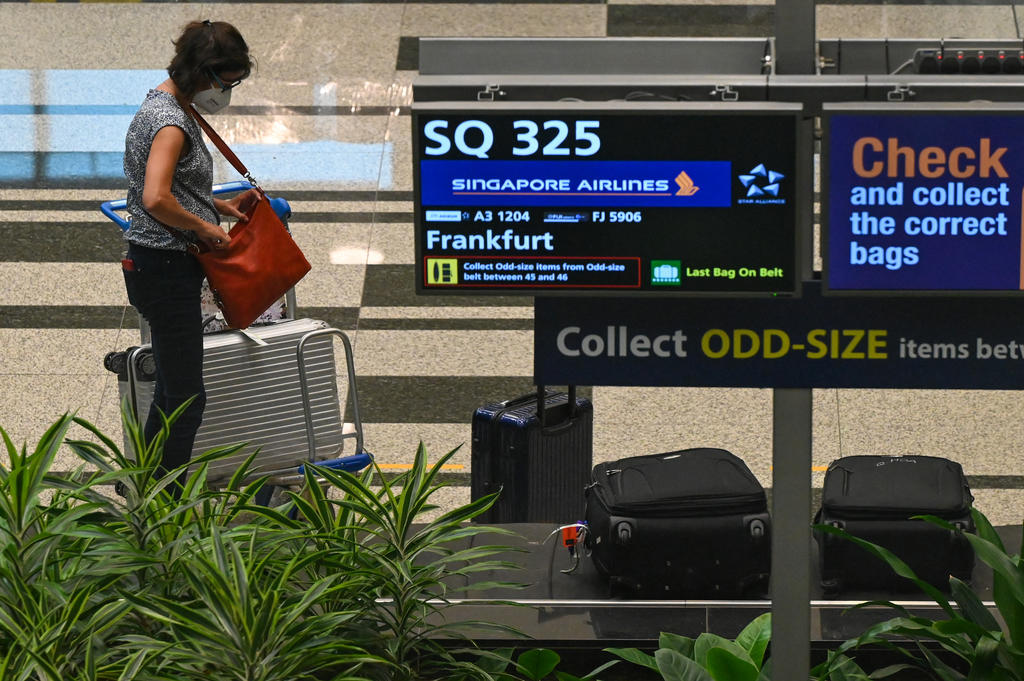 A passenger from Singapore Airlines flight SQ325 at the baggage hall of Changi Airport on September 8, 2021. u00e2u20acu2022 AFP pic
