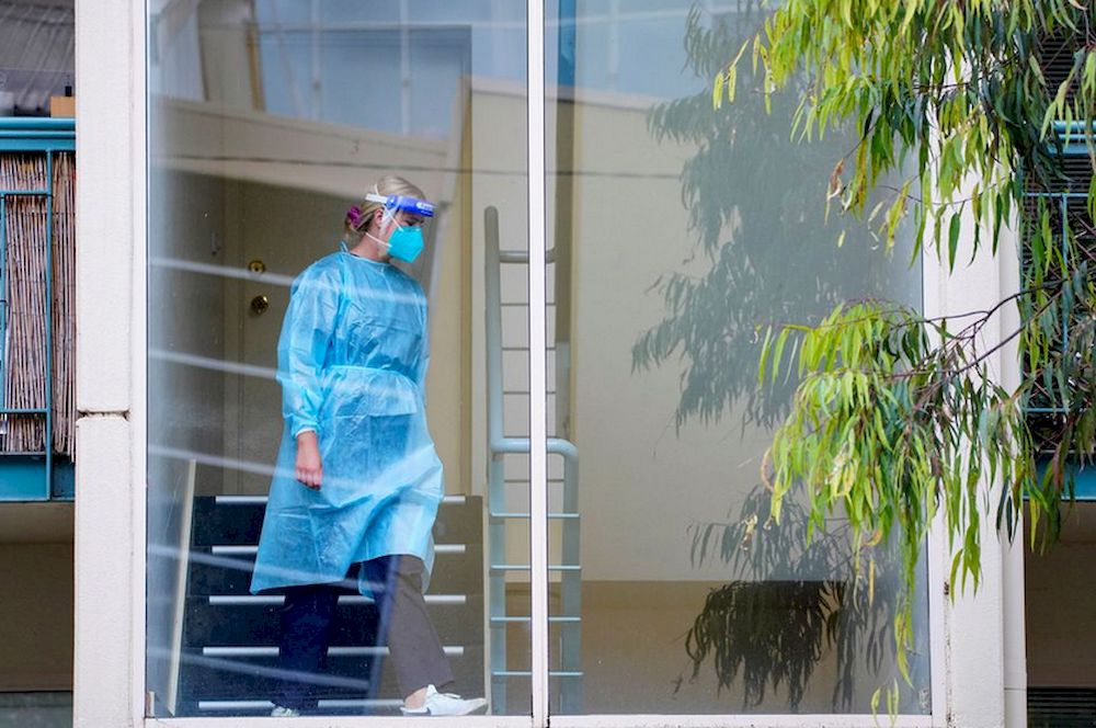 A healthcare worker walks down stairs at the Kings Park townhouse complex locked down in response to an outbreak of the coronavirus disease (Covid-19), in Melbourne, Australia, June 16, 2021. u00e2u20acu201d Reuters pic