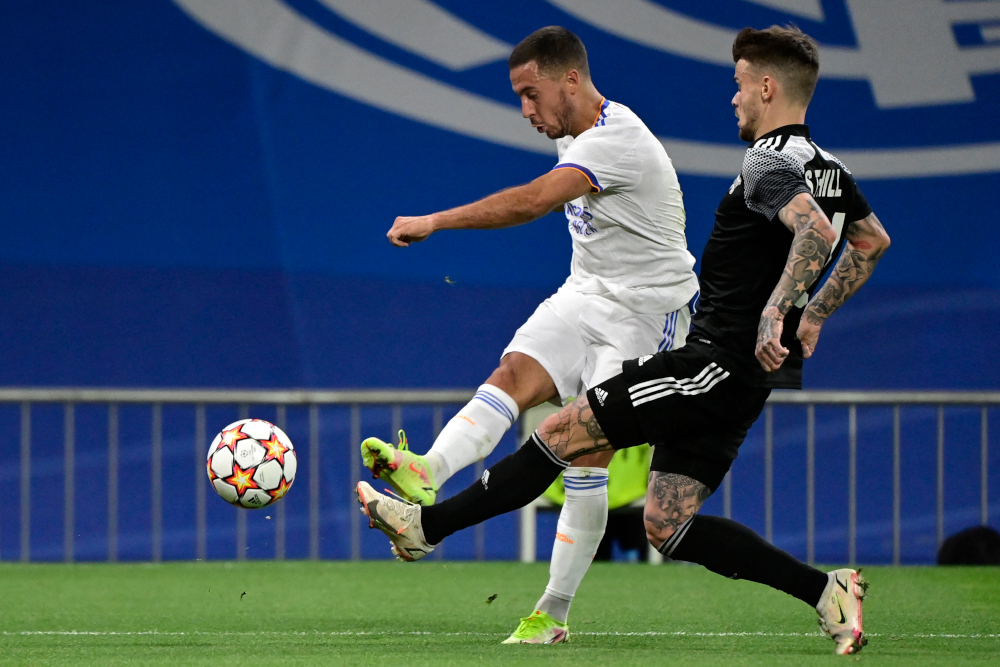 Real Madridu00e2u20acu2122s Eden Hazard vies with Sheriffu00e2u20acu2122s Sebastien Thill during the Uefa Champions League first round group D football match at the Santiago Bernabeu stadium in Madrid, September 28, 2021. u00e2u20acu201d AFP picnn