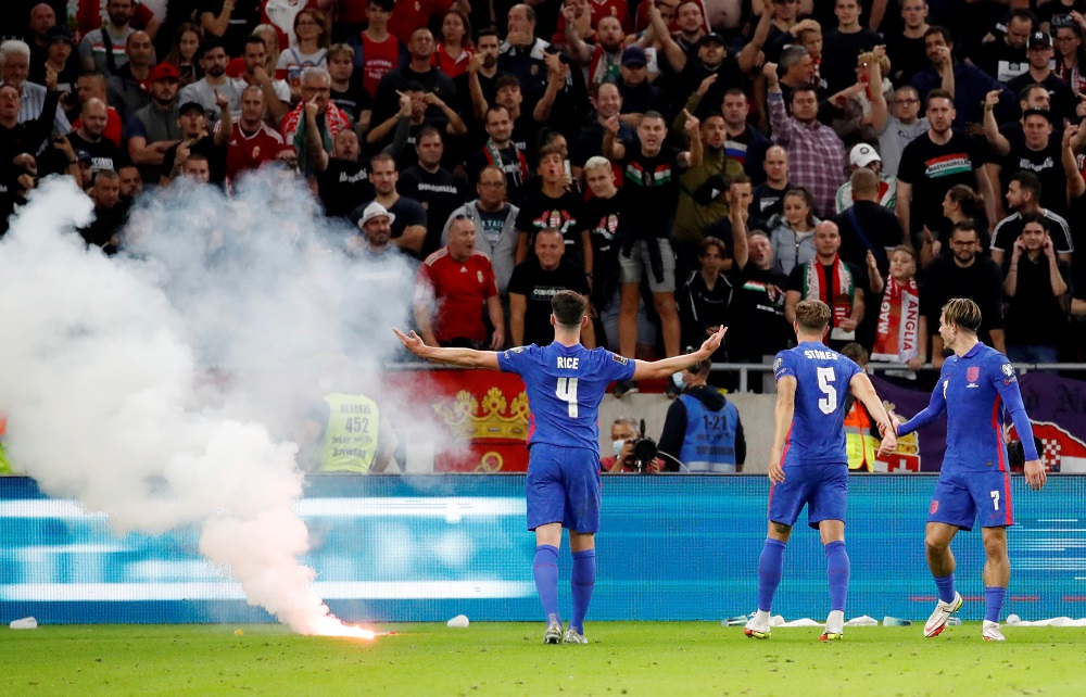 England's Declan Rice, John Stones and Jack Grealish react after a flare is thrown on to the pitch by Hungary fans after Harry Maguire scored the third goal September 3, 2021. u00e2u20acu2022 Reuters pic