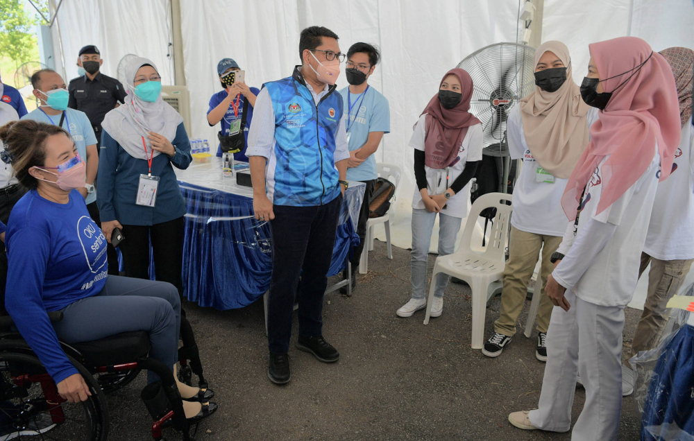 Youth and Sports Minister Datuk Seri Ahmad Faizal Azumu and OKU Sentral president Senator Datuk Ras Adiba Radzi at the OKU Sentral drive-through vaccination centre at the Johor Baru City Council Aquatic Centre, September 8, 2021. u00e2u20acu201d Bernama pic 