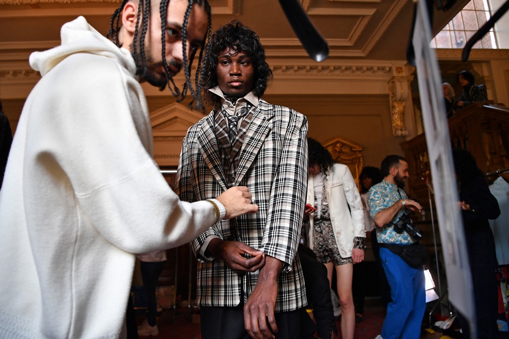 A model is prepped backstage ahead of the Edward Crutchley catwalk show on the first day of the Autumn/Winter 2020 London Fashion Week Men's, in London in January 2020. u00e2u20acu2022 AFP pic