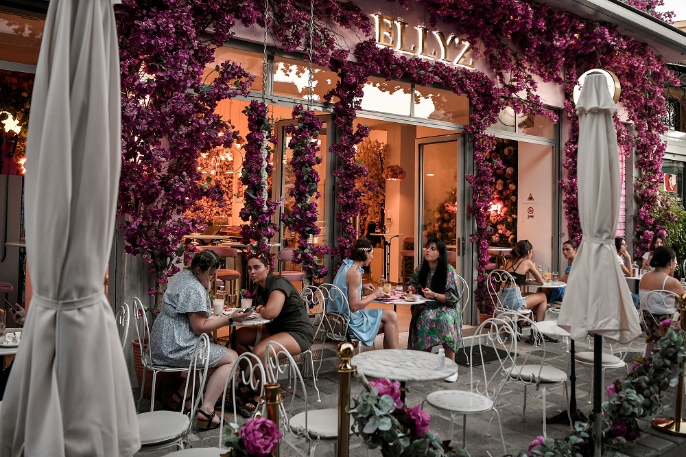 Tourists and Greek clients sit on the terrace of a cafe-bar in central Athens. u00e2u20acu2022 AFP pic