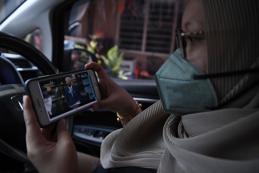 A woman watches a live broadcast of Prime Minister Datuk Seri Ismail Sabri Yaakob tabling the 12th Malaysia Plan at Dewan Rakyat, Kuala Lumpur September 27, 2021. u00e2u20acu201d Bernama picn