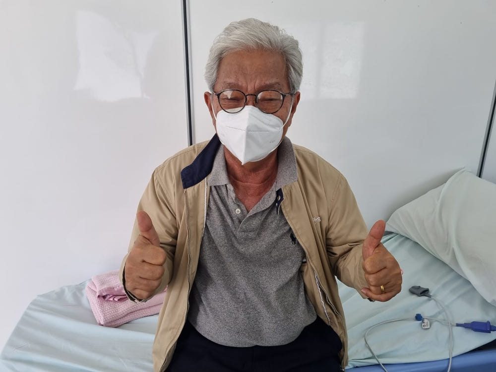 Sarawak Deputy Chief Minister Tan Sri James Masing gives a thumbs-up as he awaits transportation by ambulance to the Sarawak General Hospital in Kuching September 28, 2021. u00e2u20acu201d Picture via Facebook/Tan Sri Dr James Masing