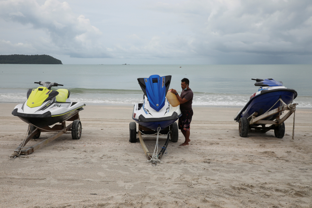 A worker fuels up a jet ski at Cenang Beach, as Langkawi gets ready to open to domestic tourists from September 16, amid the coronavirus disease (Covid-19) pandemic, in Malaysia September 15, 2021. u00e2u20acu201d Reuters pic 