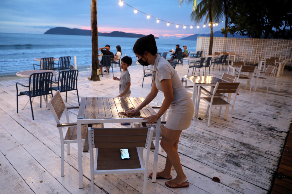 Esther Lee, Hidden Langkawi restaurant owner, cleans a table at her restaurant, as Langkawi gets ready to open to domestic tourists from September 16, amid the coronavirus disease (Covid-19) outbreak, Malaysia, September 13, 2021. u00e2u20acu201d Reuters pic 