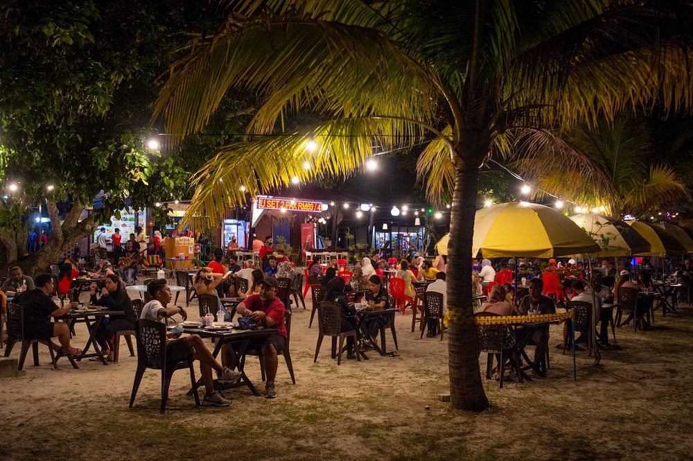 Patrons are seen here having their meals at a restaurant in Pantai Cenang September 16, 2021.