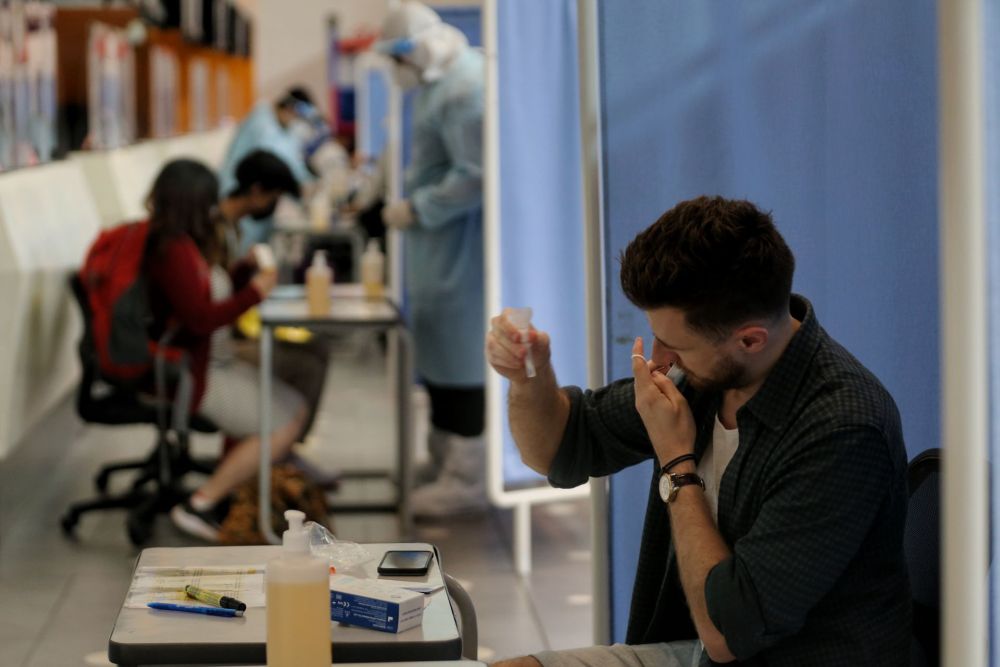 A traveller tests for Covid-19 using a rapid antigen self-test kit before his trip to Langkawi at KLIA2, Sepang September 16, 2021. 