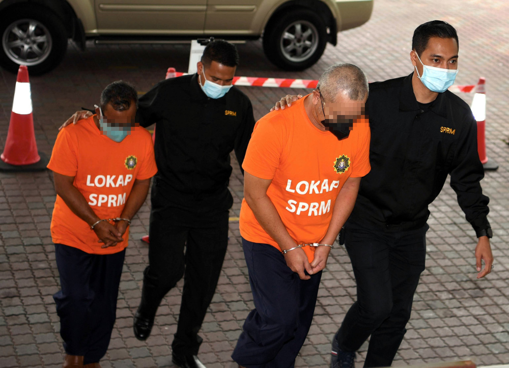 The two suspects, aged 54 and 51, arriving at the Sultan Salahuddin Abdul Aziz Court Complex at 10am accompanied by MACC officers, September 10, 2021. u00e2u20acu201d Bernama pic 