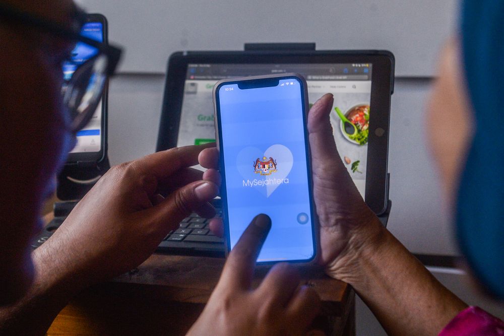 Housewife Kamisah Sies launches the MySejahtera app in Kuala Lumpur September 23, 2021. u00e2u20acu2022 Picture by Miera Zulyana
