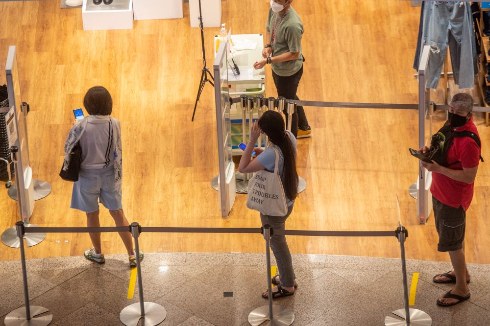 Patrons line up as they wait to enter one of the stores at a shopping mall in Kuala Lumpur during Phase Two of the National Recovery Plan on September 10, 2021. u00e2u20acu201d Picture by Shafwan Zaidon