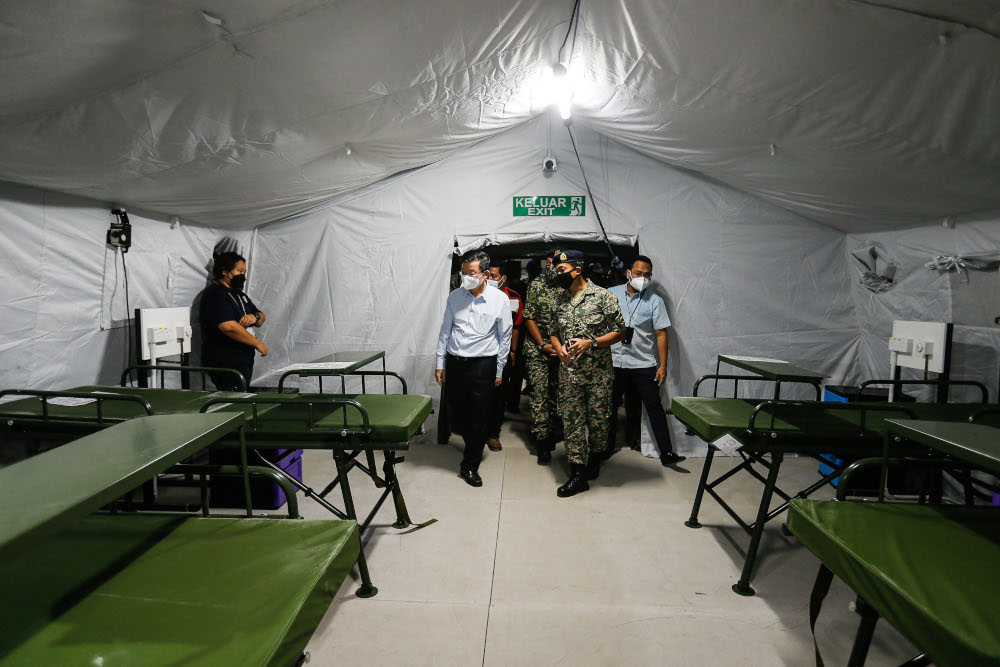Penang Chief Minister Chow Kon Yeow being briefed by Lieutenant Colonel Dr Zamri Derahman (centre) during the dry run of the Royal Malaysian Army Field Hospital at Penang General Hospital, September 24, 2021. u00e2u20acu201d Picture by Sayuti Zainudinnn